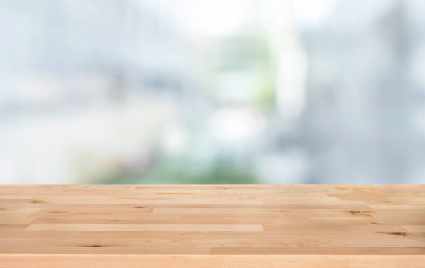 istock Selective focus of wood table top on white wall glass (big window) background 1191372249