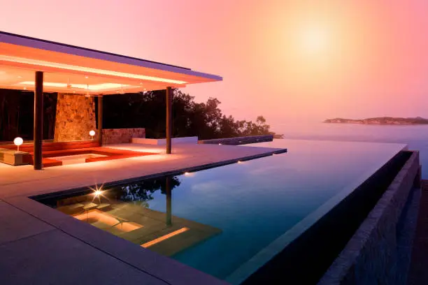 Luxury Island Home With Infinity Pool At Dusk.