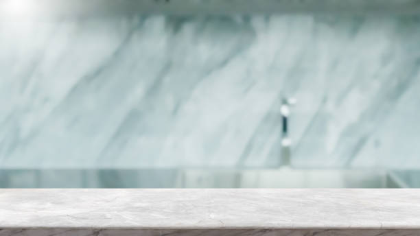 istock Empty white marble stone table top and blurred kitchen interior background with vintage filter - can used for display or montage your products. 1191378259