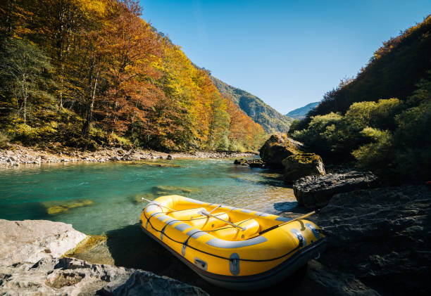 Inflatable raft sits on shore of river