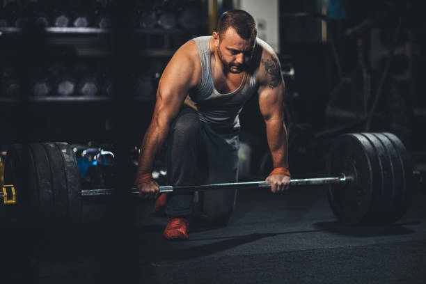 istock Body builder exercising in dark gym 1191379594