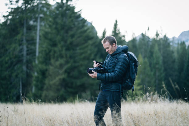 istock Young man hiking films forest 1191380363