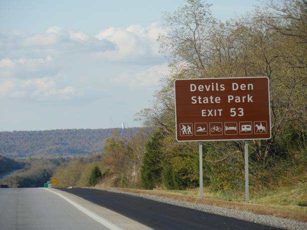istock Roadside sign with exit directions to Devils Den State Park at Interstate 49, Arkansas. 1191381746