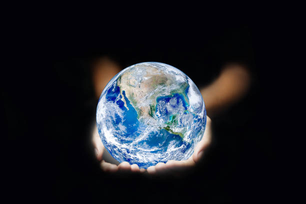 istock Ecology Concept : Hand holding blue planet earth globe in dark light. 1191385471