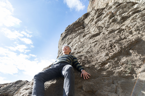 Senior man enjoying rock climbing
