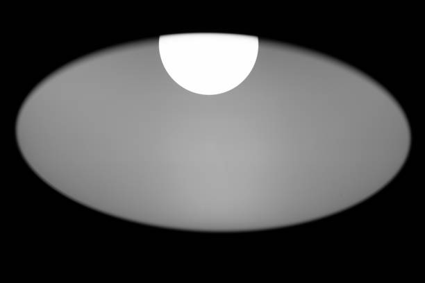 Lampshade outlines on black background