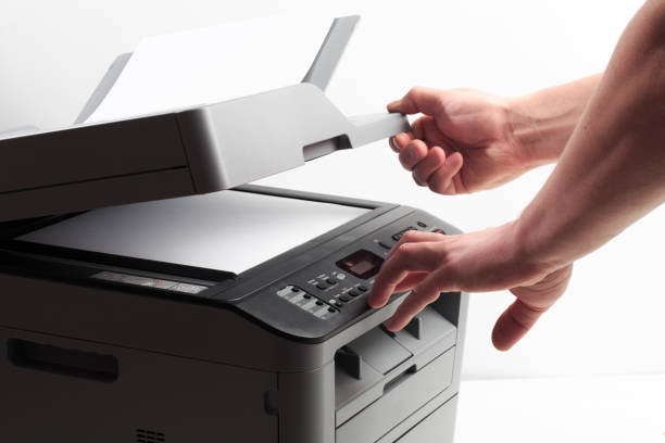 istock Hand press button on panel of printer. printer scanner laser office copy machine supplies start concept 1191386981