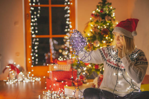 istock Woman preparing string lights for a Christmas decoration 1191388155