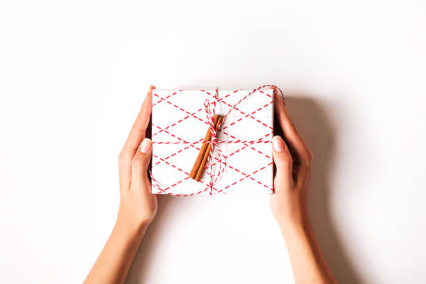 istock Woman's hands holding gift box on white background. 1191388665