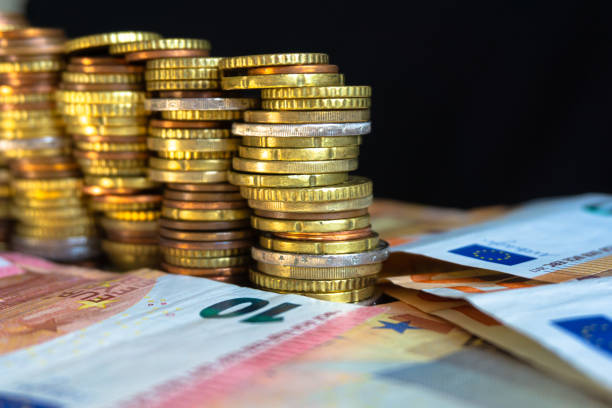 istock Euro coins are lined up with Euro bank notes. 1191391269