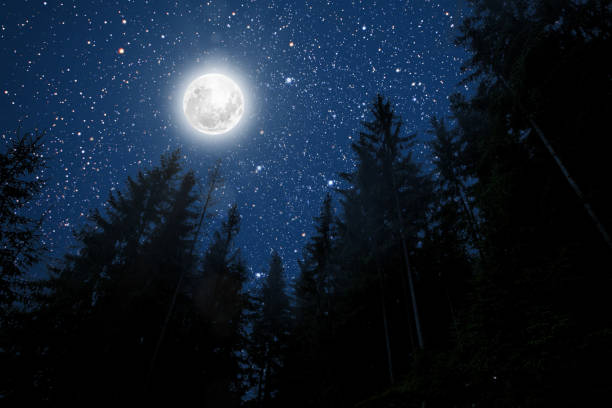 istock backgrounds night sky with stars and moon and clouds. 1191392592