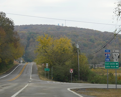 Side roads with directional signs and distances to Fort Smith and Little Rock in Arkansas.