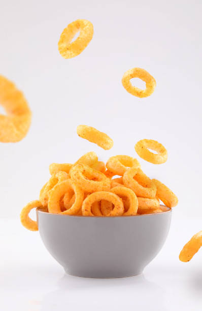 istock puffed corn rings chips in  gray bowl on white background 1191394330