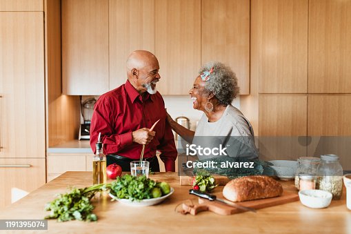 istock Cheerful senior couple preparing vegan meal in kitchen 1191395074