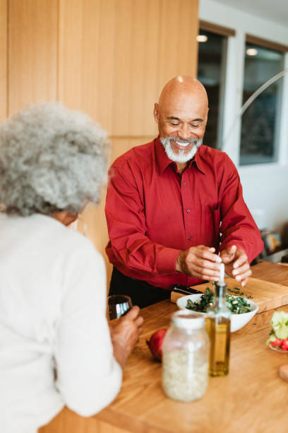 istock Smiling bald retired man preparing meal by wife 1191395210