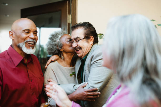 istock Smiling party host greeting guest at front yard 1191395397