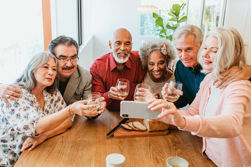 Woman taking selfie with friends at brunch party