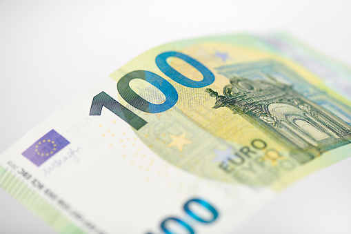 High resolution photograph of an 100 Euro bill (version since 2019), selective focus.