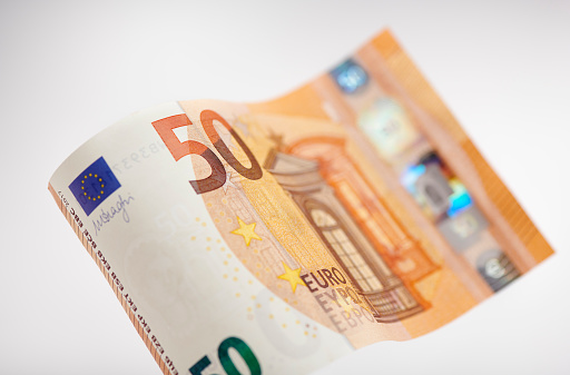 High resolution photograph of a waved 50 Euro bill, shalow depth of field.