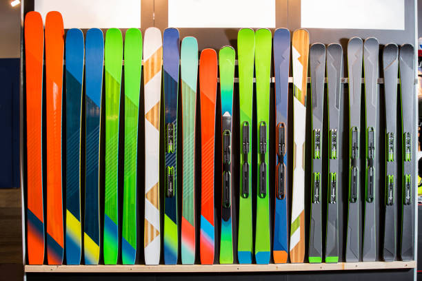 Two vintage weathered water skis on a yellow background