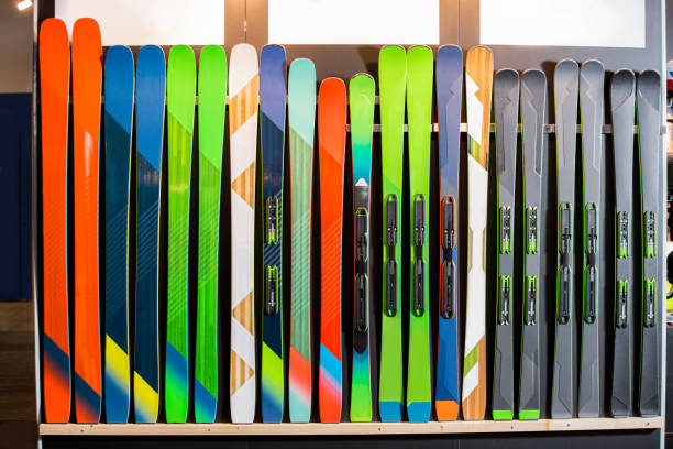 Rows of colourful skis on wall. stock photo