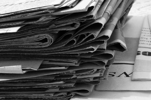 istock Newspapers Folded and Stacked in Pile 1191401175