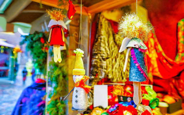istock Small handmade statues hanging on display at Riga Christmas market reflex 1191401211