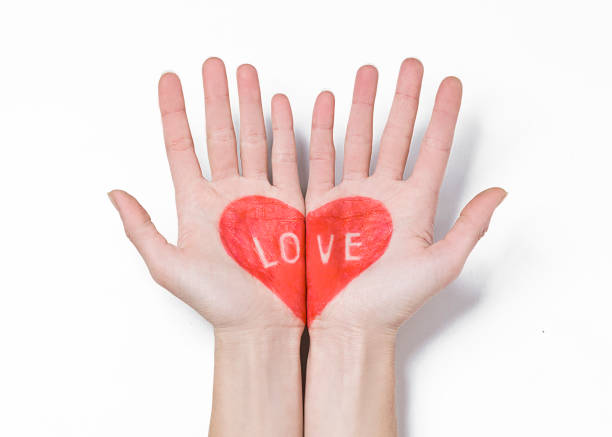 istock Heart painted on the hands on white background. 1191401281