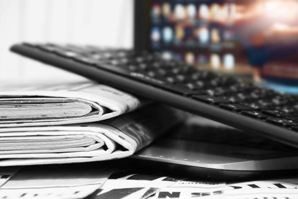istock Newspapers and Laptop 1191401309