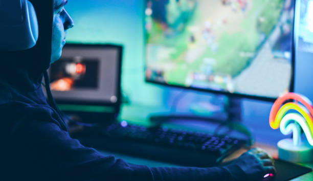 istock Young streamer gamer playing at strategy game in broadcast browser - Male guy having fun gaming and streaming online - New technology game trends and entertainment concept - Soft focus on his eye 1191401487