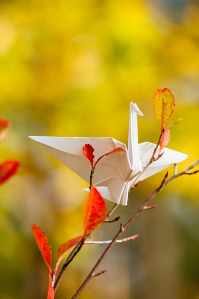 istock Origami crane on a tree branch 1191401502