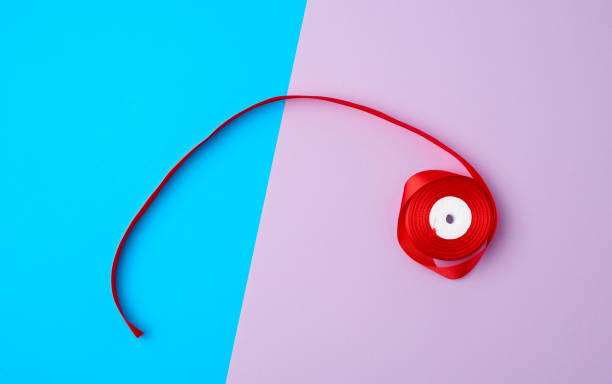 istock spools with red satin ribbon on a color background 1191402581
