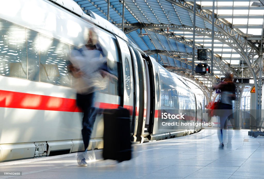 Sunlit Railroad station in Germany German ICE fast train on a platform Train - Vehicle Stock Photo