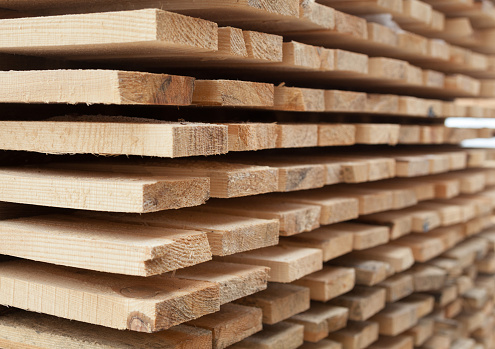 Wooden planks. Air-drying timber stack. Wood air drying (seasoning lumber or wood seasoning). Timber. Lumber. Close-up.