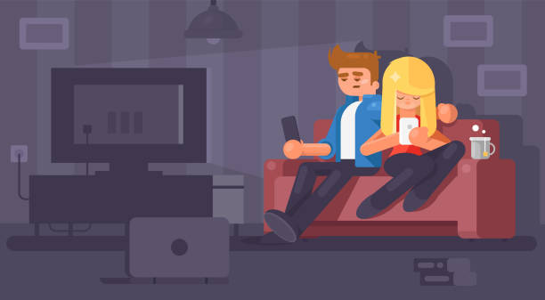 junge familie, die zu hause auf der couch sitzt. - gamer watching tv adult couple stock-grafiken, -clipart, -cartoons und -symbole