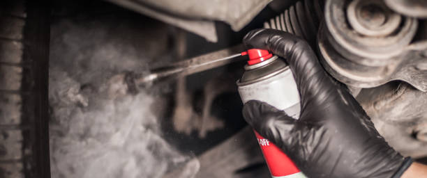 istock Car master mechanic repairer lubricates screws with machine cleaner spray 1191405052
