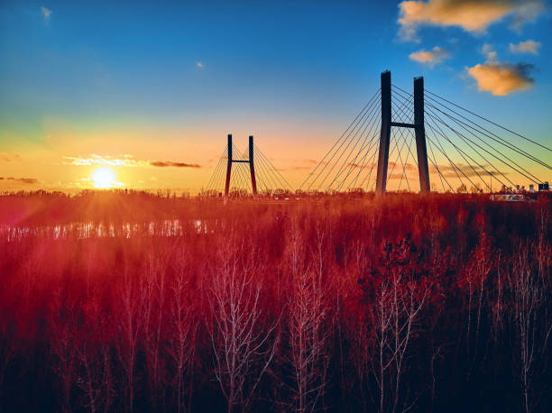 istock Beautiful panoramic aerial drone view to cable-stayed Siekierkowski Bridge over the Vistula river and Warsaw City skyscrapers, Poland in gold red autumn colors in November evening at sunset 1191405467