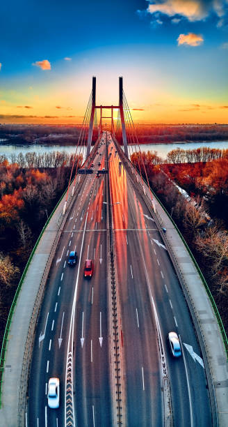istock Beautiful panoramic aerial drone view to cable-stayed Siekierkowski Bridge over the Vistula river and Warsaw City skyscrapers, Poland in gold red autumn colors in November evening at sunset 1191406209