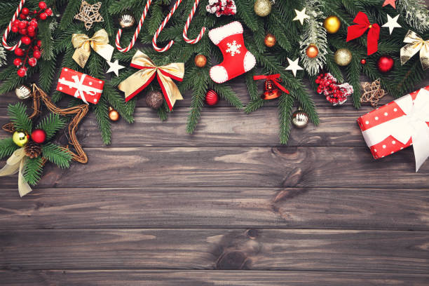 istock Christmas tree branches with toys on wooden table 1191406913