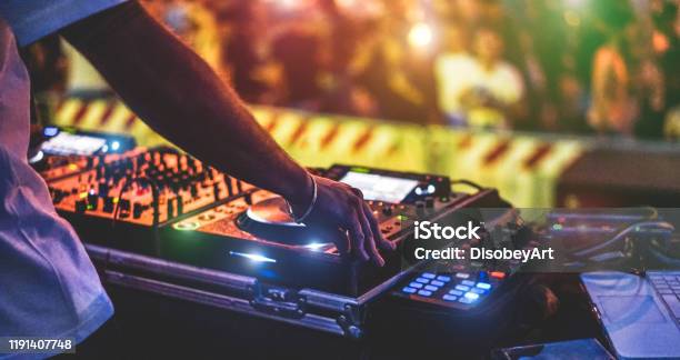 Dj Mixing Outdoor At New Year Party Festival With Crowd Of People In Background Nightlife View Of Disco Club Outside Soft Focus On Bracelet Hand Fun Youthentertainment And Fest Concept Stock Photo - Download Image Now