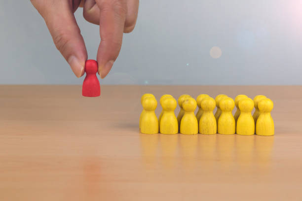 istock Hands choose the tree man who stands out in the crowd. 1191407846
