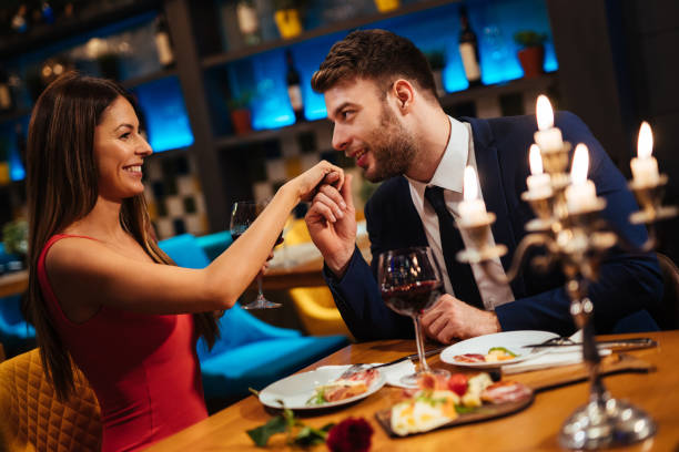 istock Man kissing his girlfriend’s hand during romantic dinner 1191407904