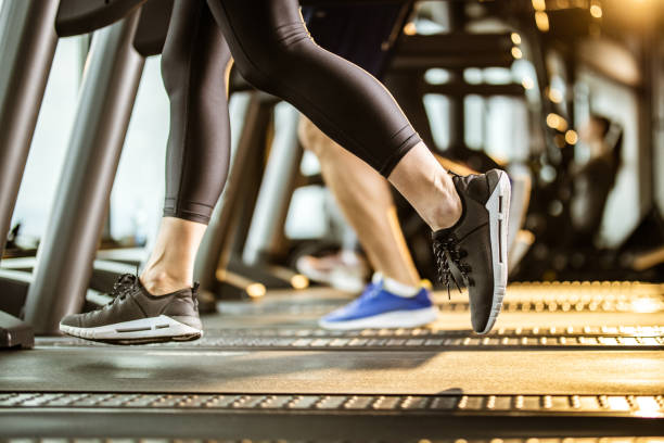 istock Unrecognizable female athlete running on a treadmill in a gym. 1191408562