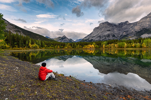 Man traveler relaxing in Wedge pond at morning on Kananaskis country, Canada