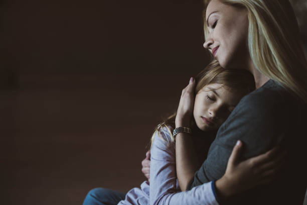 istock Affectionate single mother and her daughter embracing at home. 1191409423