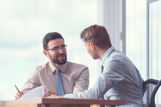 istock Smiling businessmen at the meeting 1191409902