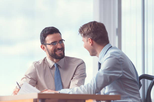 istock Smiling business people signing a contract 1191409970
