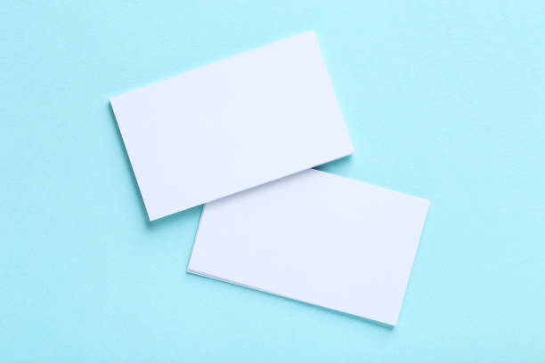 istock Blank business cards on blue background 1191411538