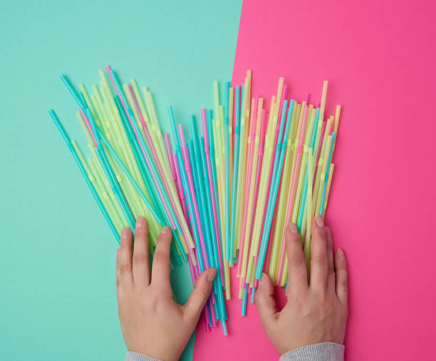 istock female hand holding multicolored plastic cocktail tubes 1191412599
