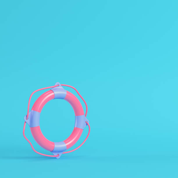 istock Pink llife buoy on bright blue background in pastel colors 1191413270